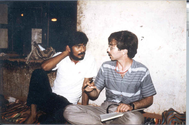 Dg with tirtha Two men seated cross legged on the floor in conversation